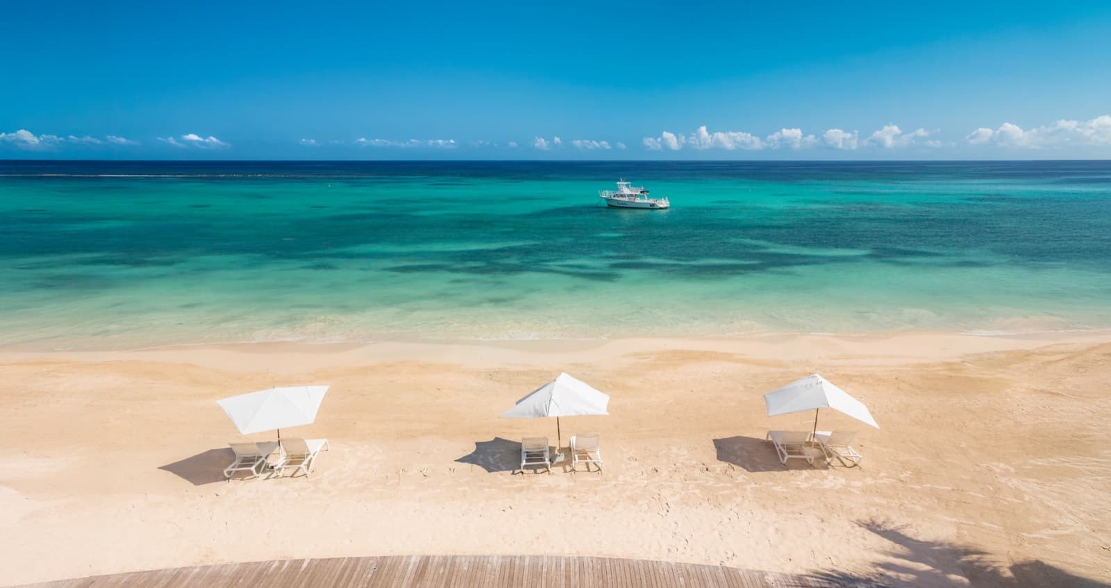 Beach loungers and umbrellas on a calm Caribbean shore