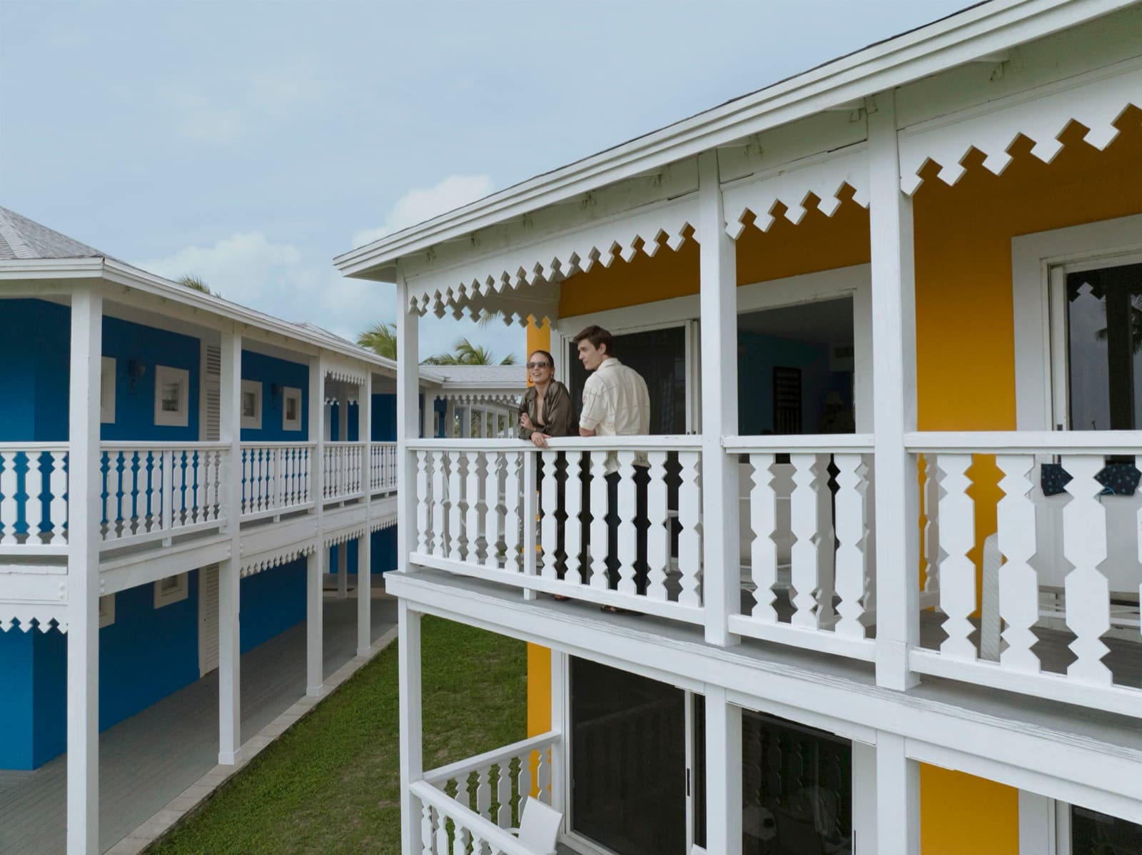 Gingerbread balconies on the blue and yellow bungalows