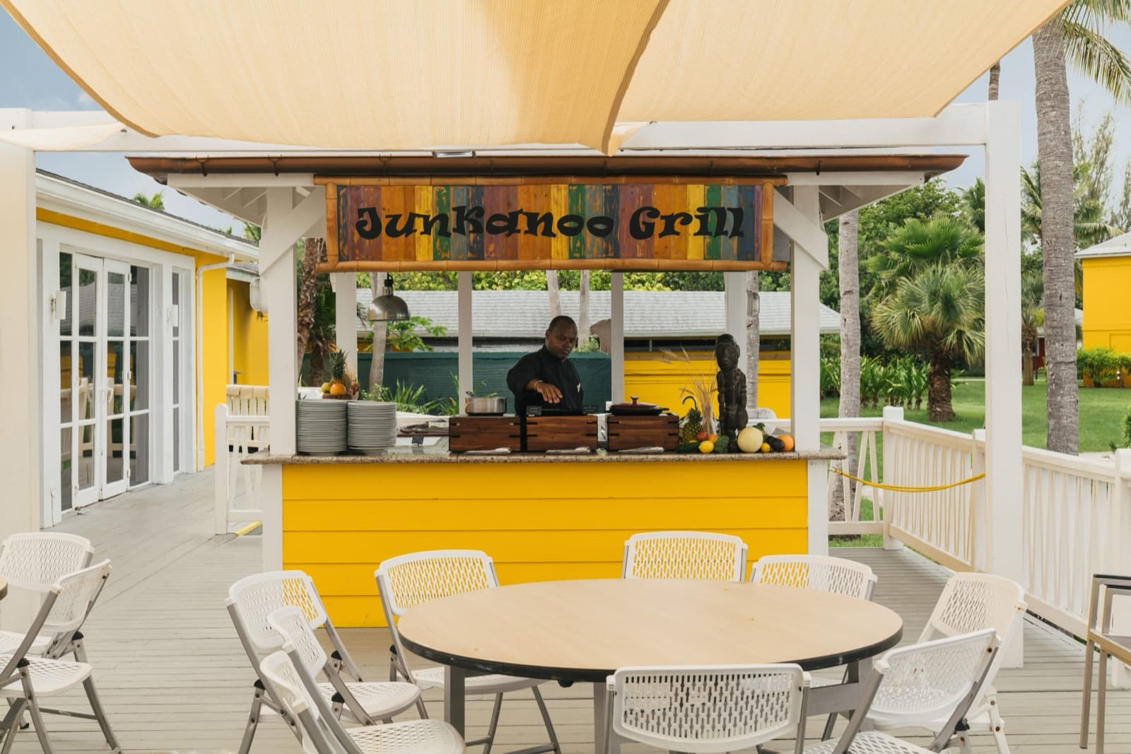 The beachside grill at Club Med Columbus Isle, bright yellow under shade sails