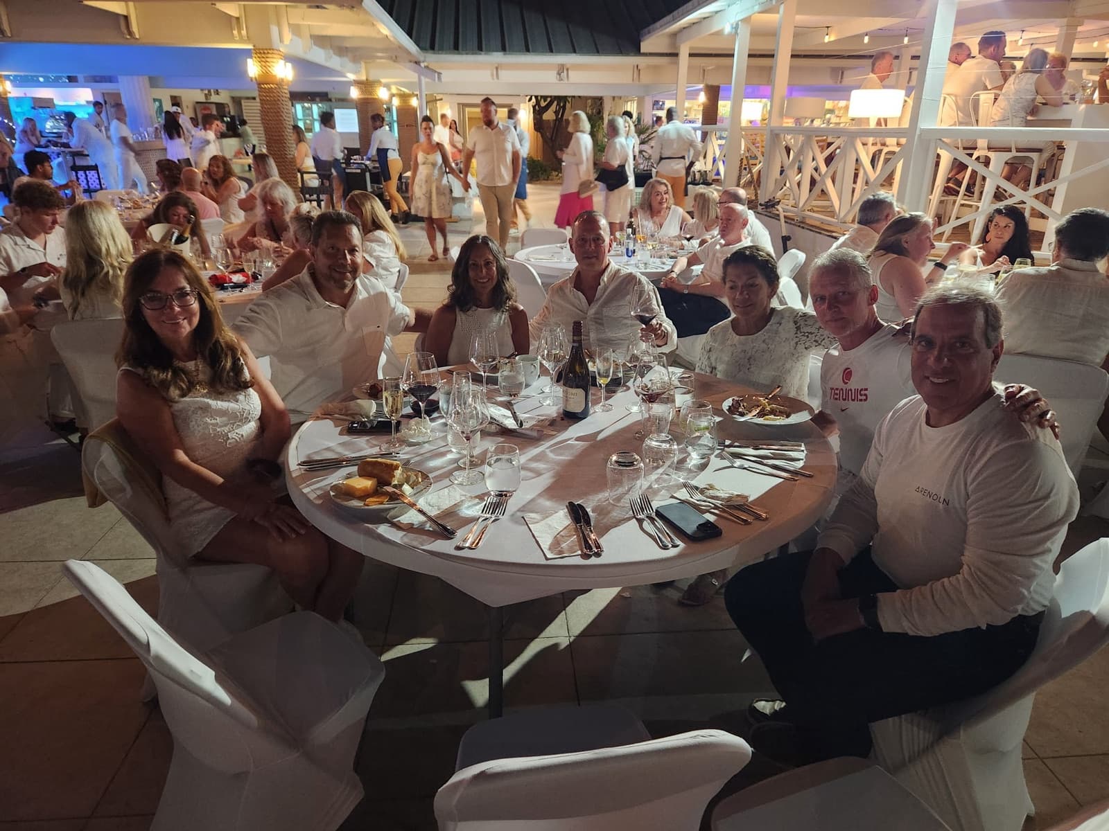 The whole crew in white at a resort dinner — White Night