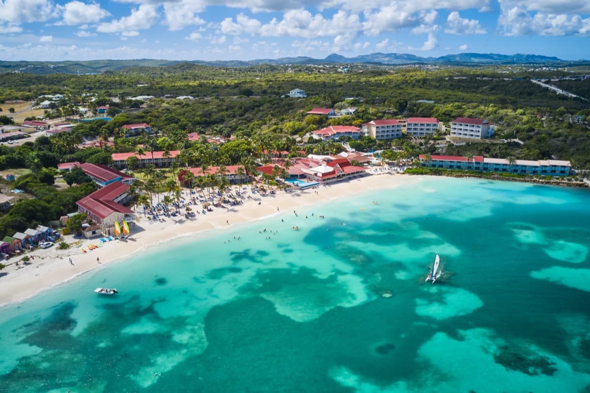 Aerial view of Pineapple Beach Club's white-sand beach and turquoise water in Antigua