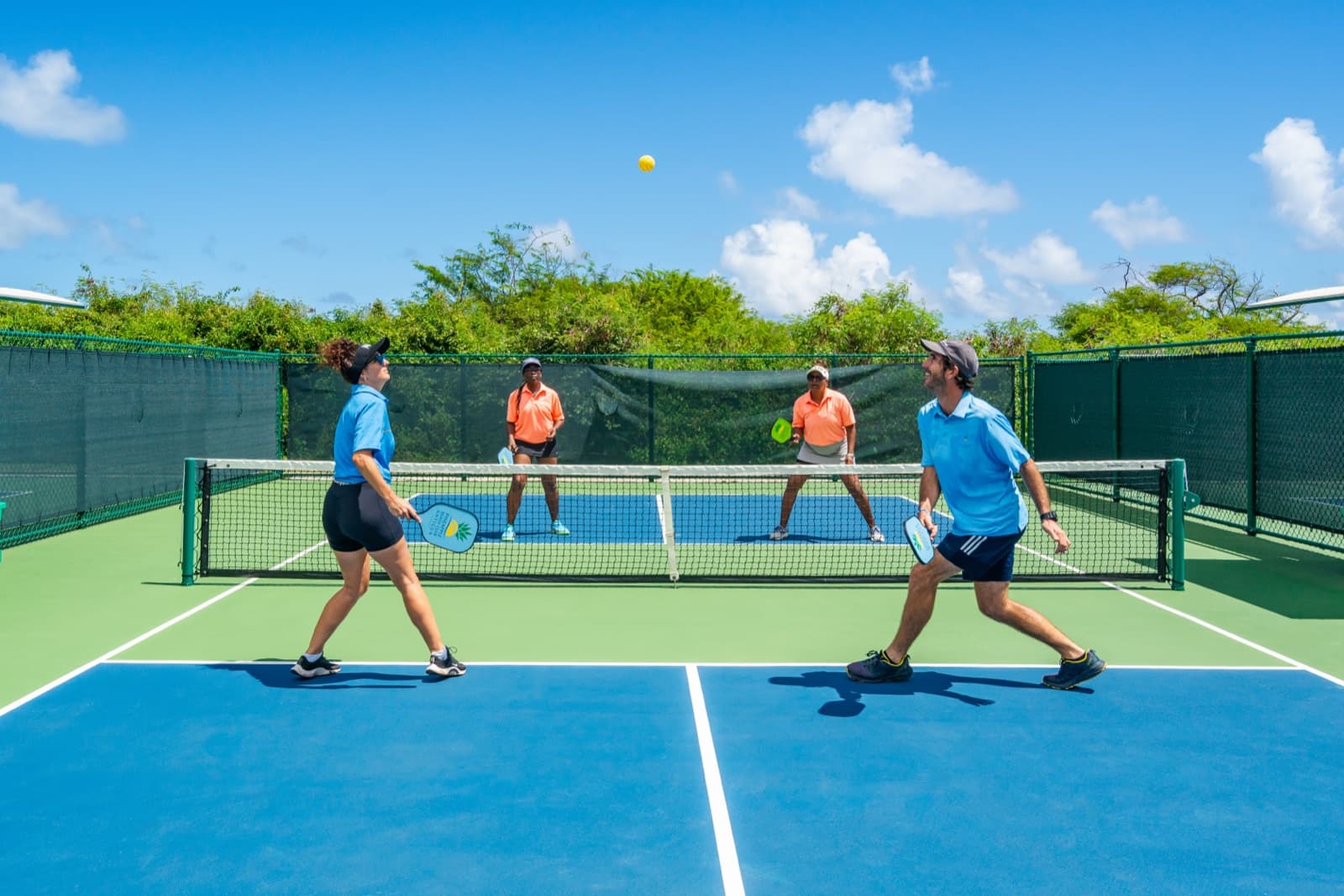 Pickleball action on one of the six courts
