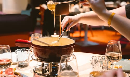 A bubbling Swiss cheese fondue on the table at The Grischa, the resort's main restaurant