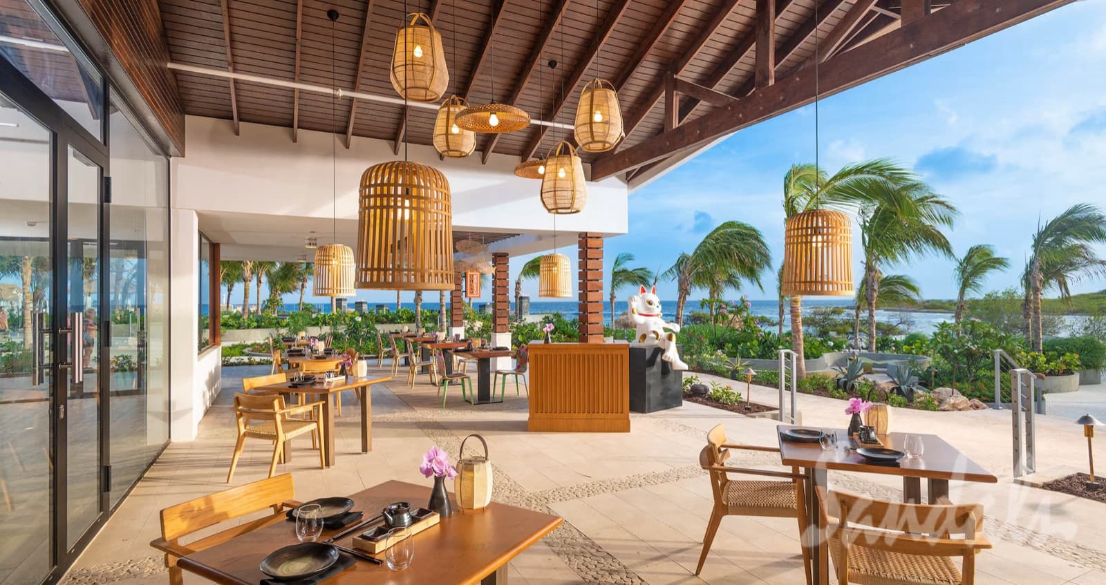 Open-air dining room at Sandals Royal Curaçao overlooking the water
