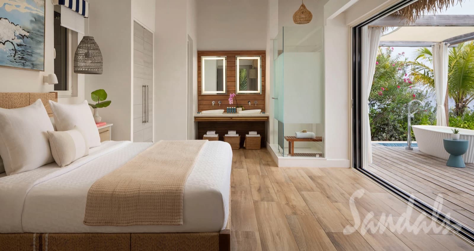 A guest room at Sandals Royal Curaçao opening onto a private terrace
