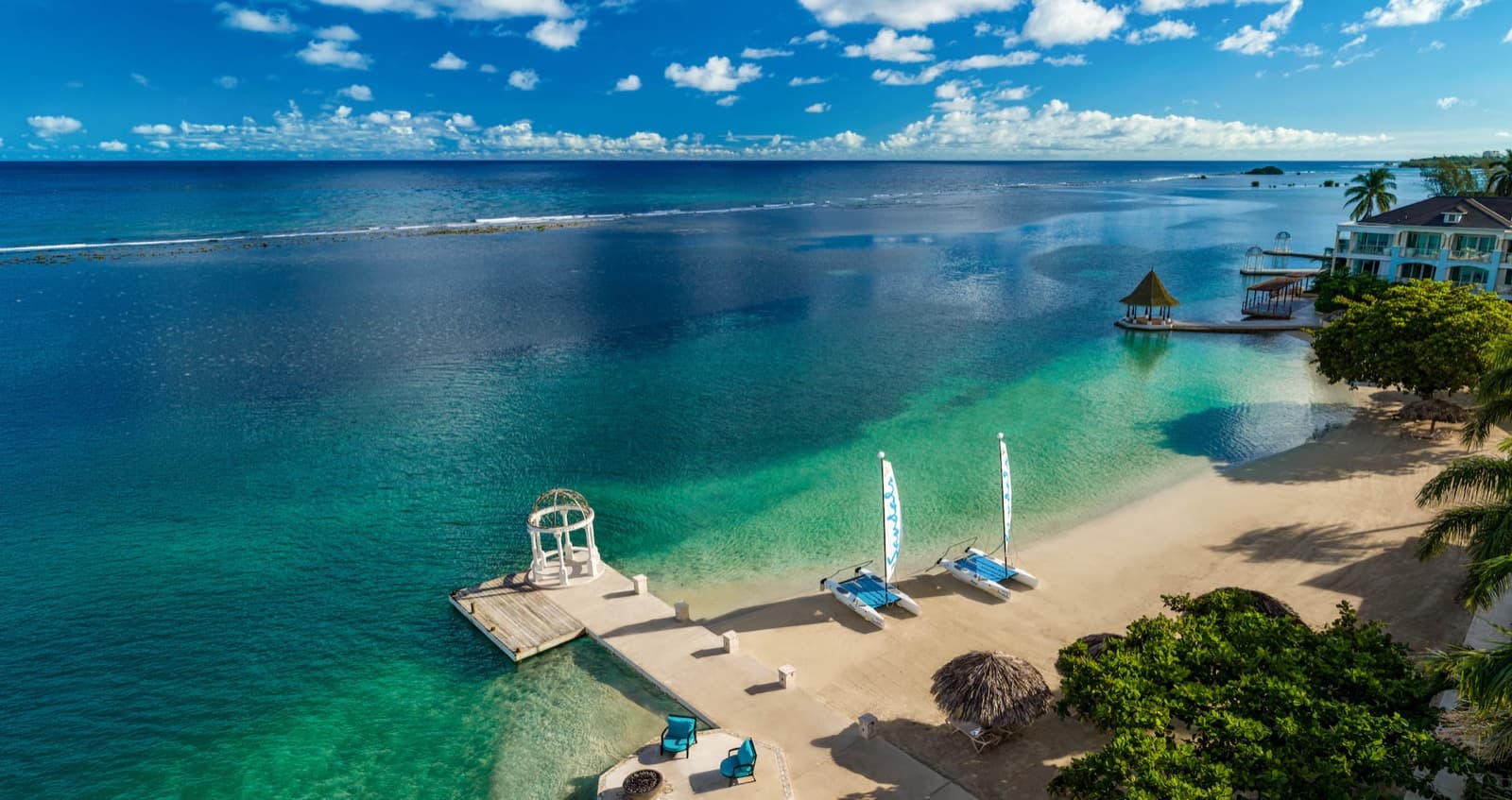 Catamarans on a turquoise Sandals beach