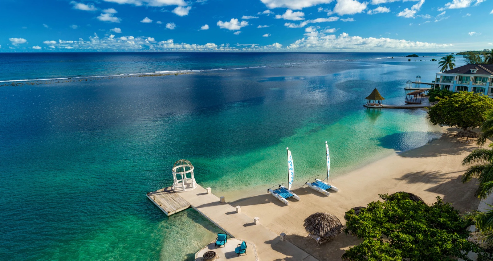Catamarans on a turquoise Sandals beach