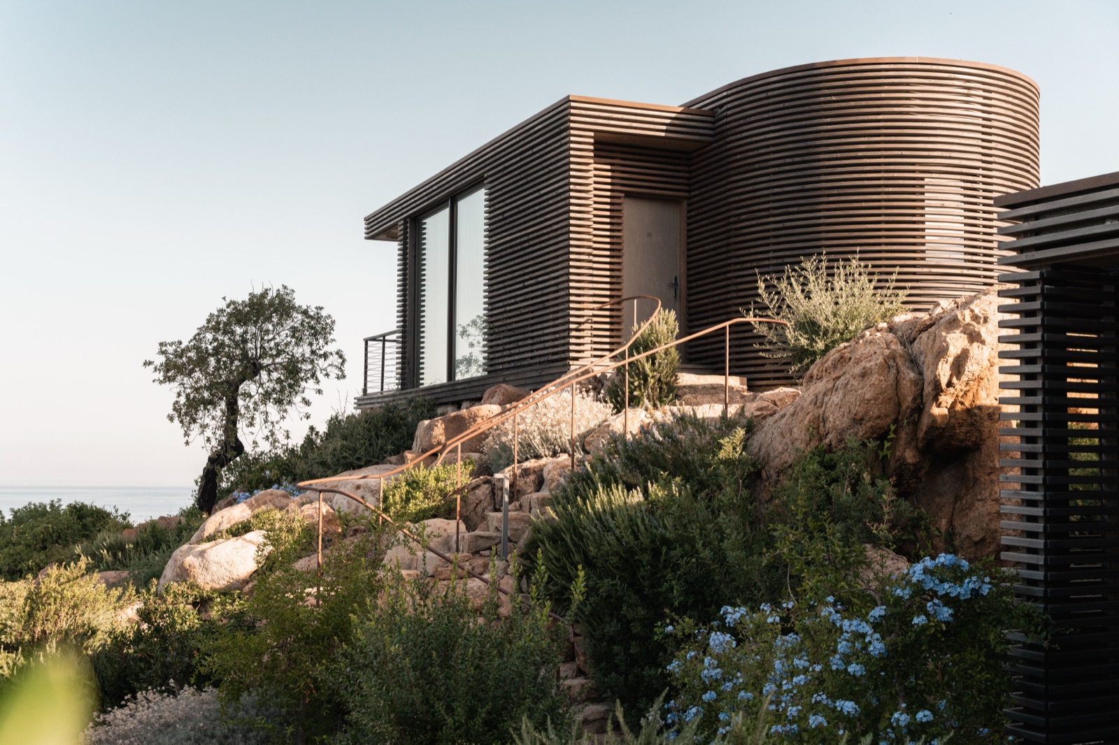 A clifftop villetta above the rocks at Club Med Cefalù, sea horizon beyond