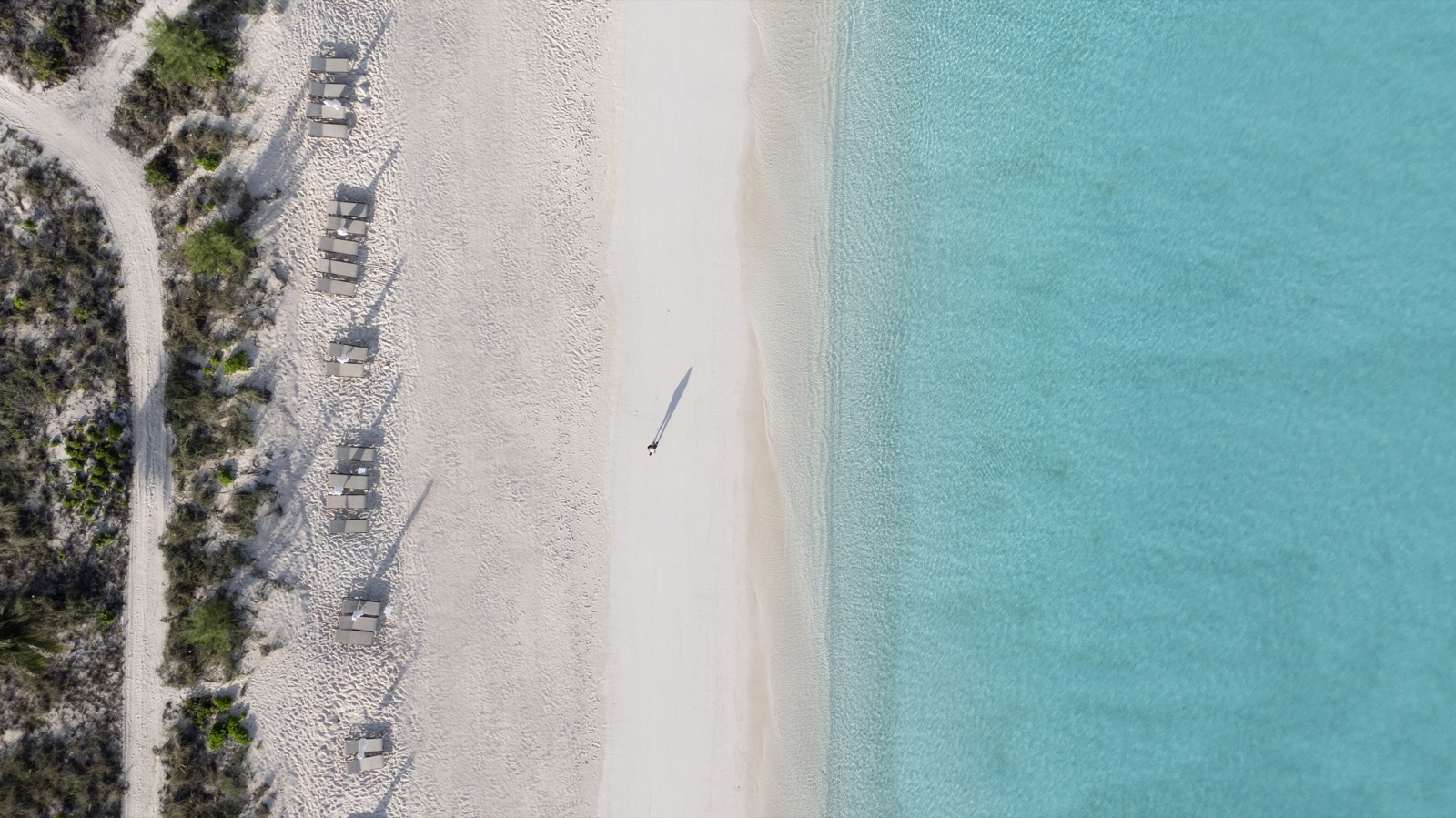 White-sand beach and turquoise shallows on San Salvador, from above